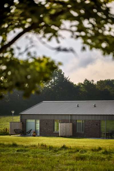 Past and future meet in steel-clad terraced houses with history in the backyard, Jernaldervej 8, 8600 Silkeborg, Denmark